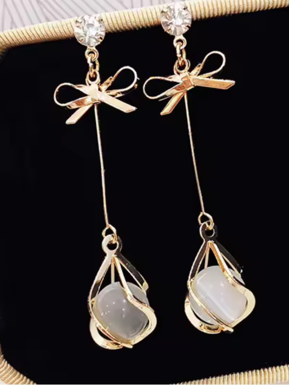 Anthropologie Gold Tone Ribbon Drop Earrings with White Stones